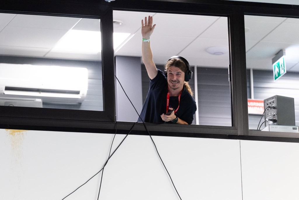 Dawid Suchodolski waves from the production booth during the closing ceremony of the World Championships in Vilnius